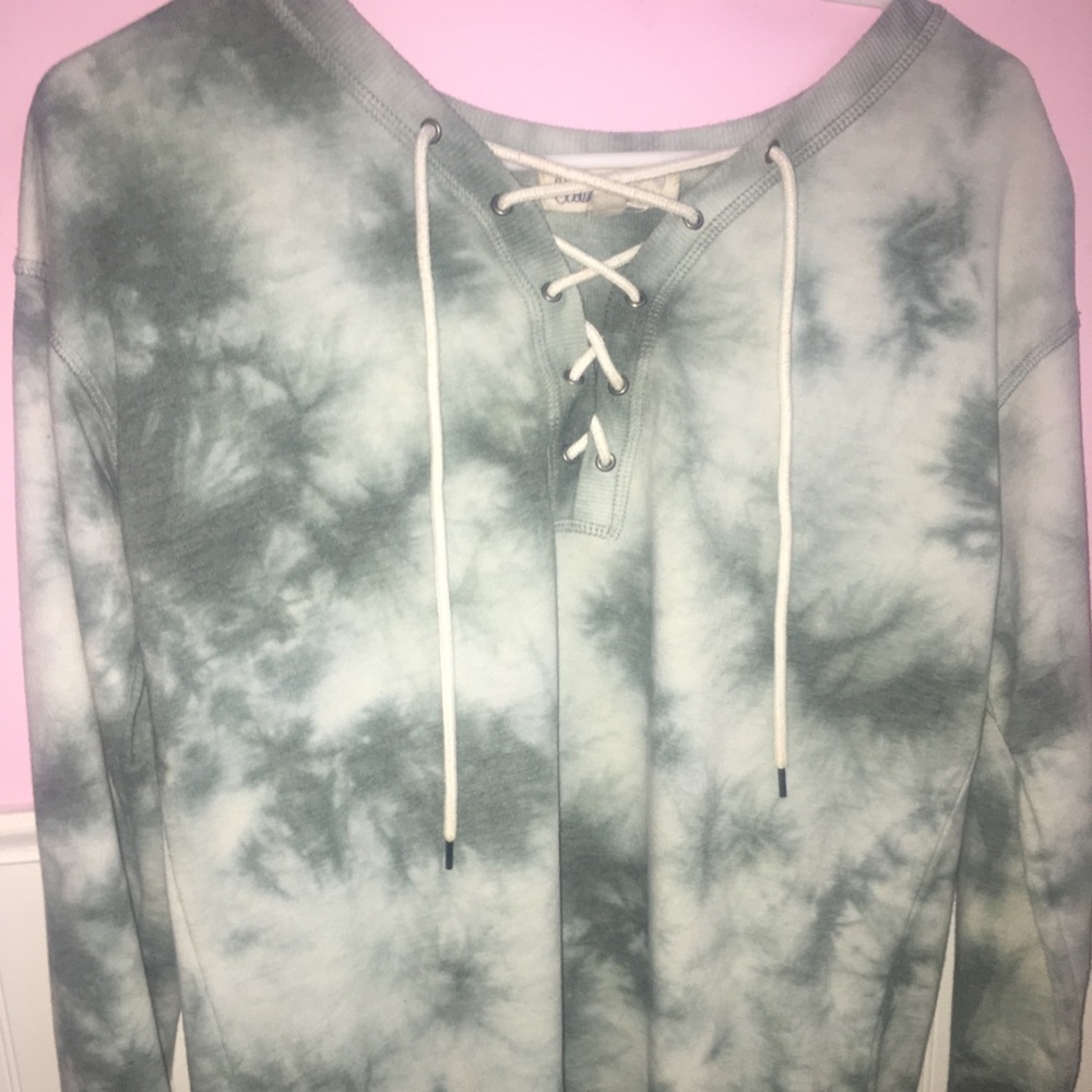Green tie dye sweater with cross-tie in front.